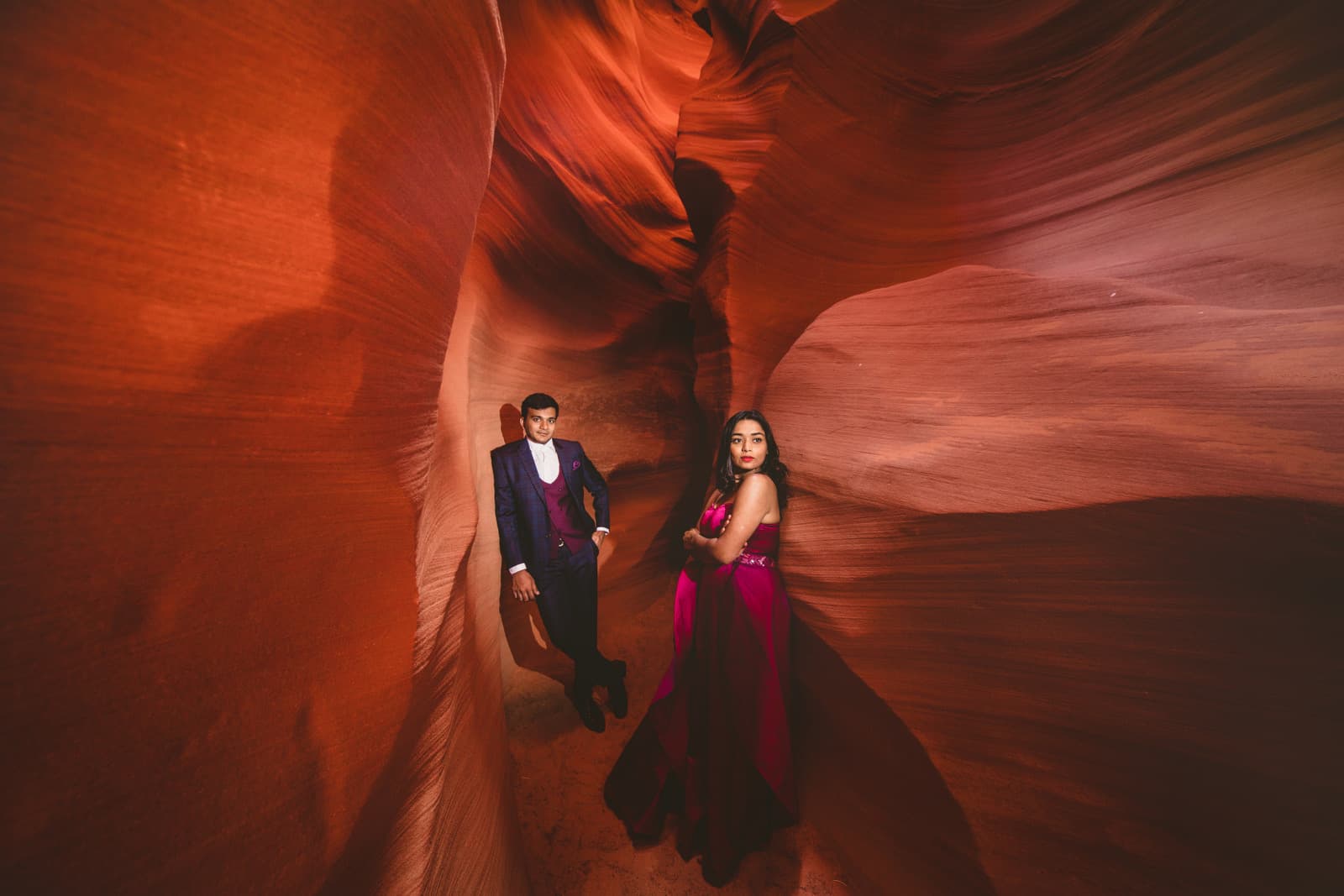 A couple inside the sandstone curves of Antelope Canyon