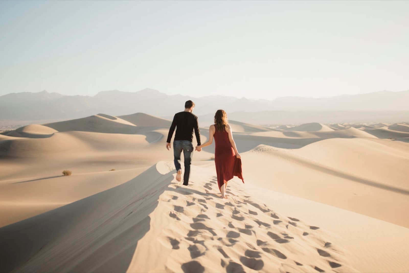 A couple walks a dune ridge at Mesquite Flat in Death Valley
