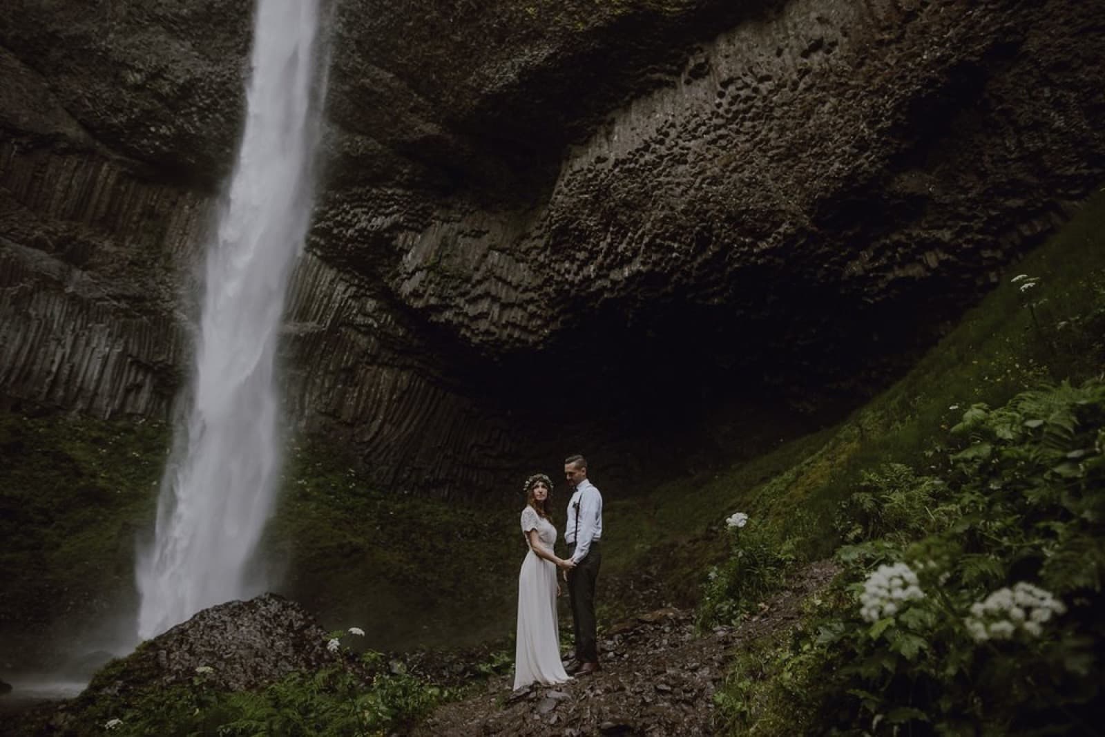 A couple beneath Latourell Falls in the Columbia River Gorge