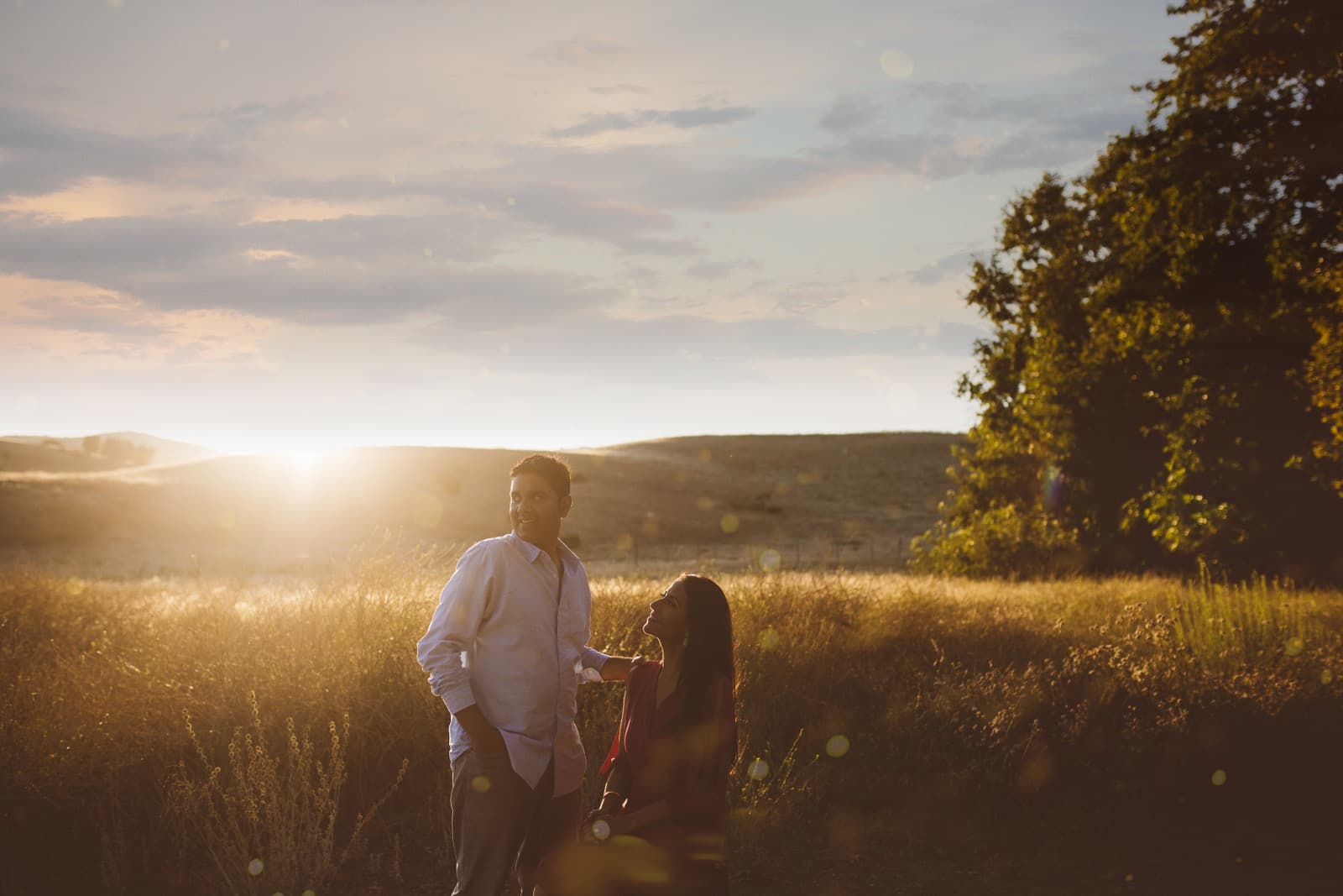 A couple in the golden hills outside San Francisco at sunset